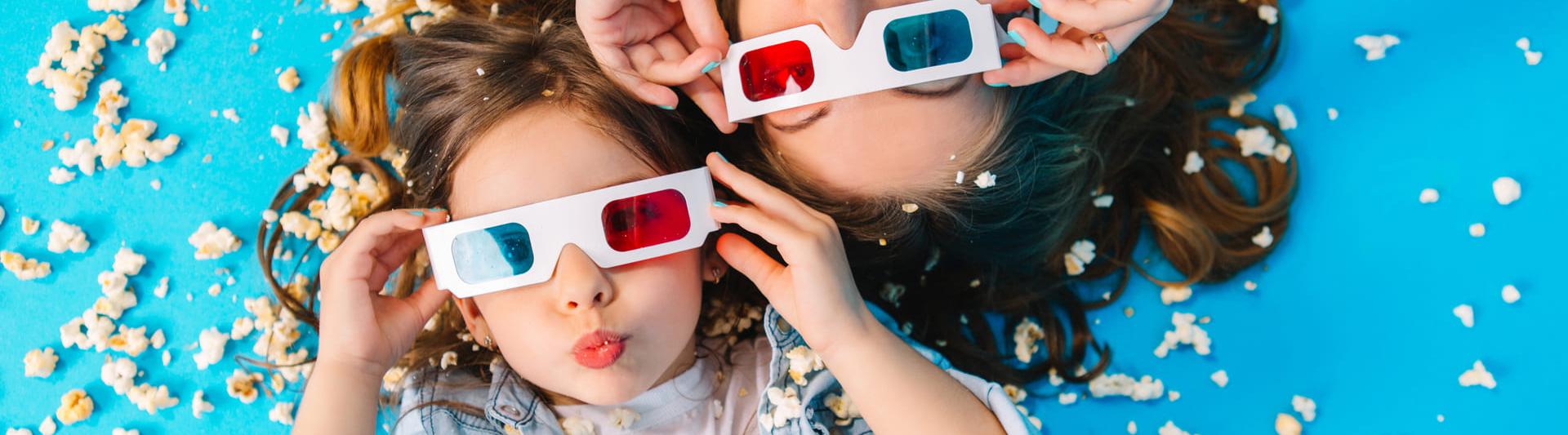view-from-funny-mother-daughter-laying-floor-having-fun-camera-popcorn-isolated-blue-background-fashionable-family-jeans-clothes-wearing-3d-glasses-express.jpg