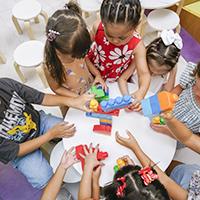 top-view-non-binary-kids-playing-with-colorful-game.jpg