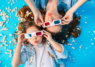 view-from-funny-mother-daughter-laying-floor-having-fun-camera-popcorn-isolated-blue-background-fashionable-family-jeans-clothes-wearing-3d-glasses-express.jpg